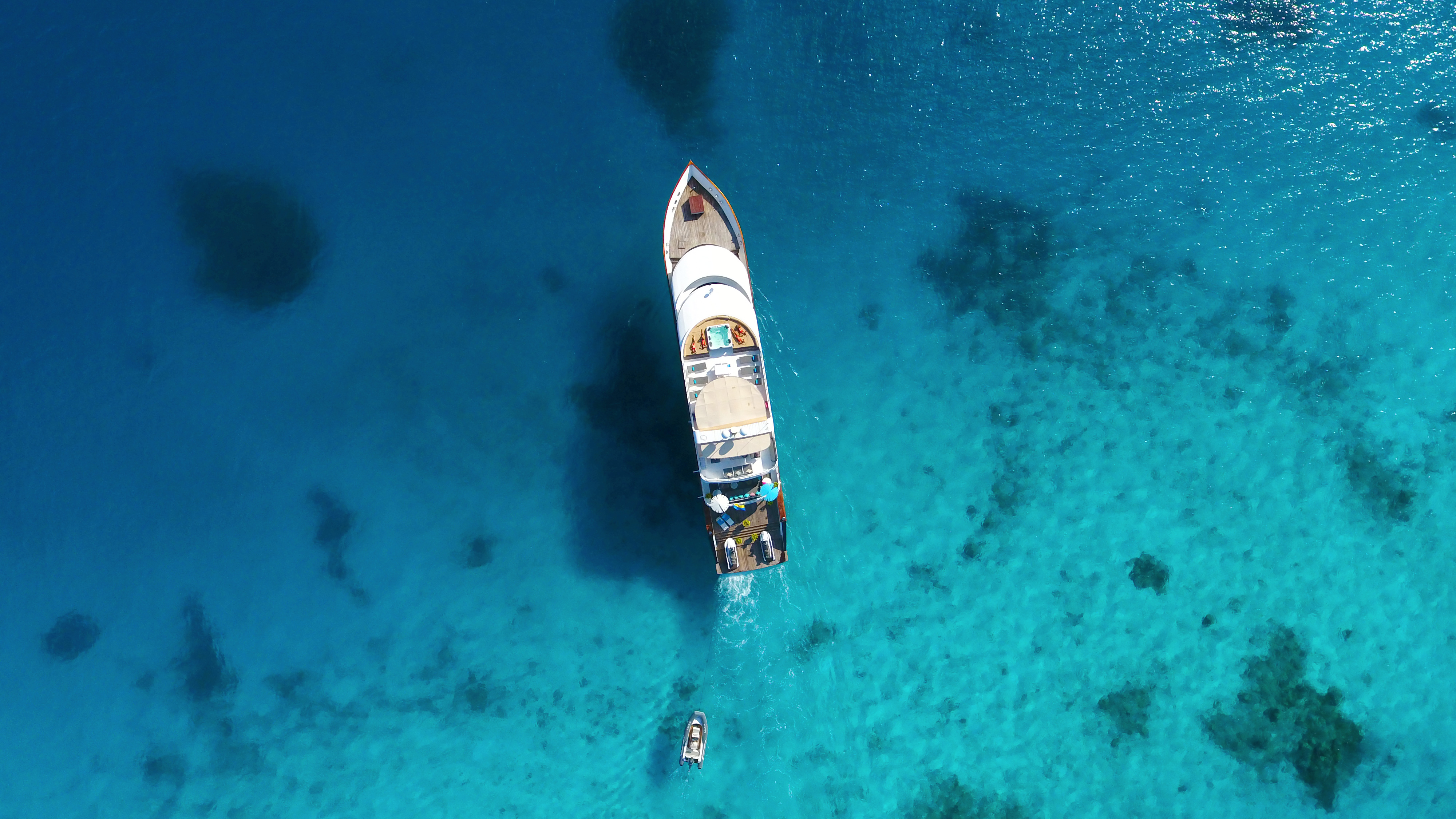 Aerial view of Azalea cruising through the turquoise atolls of the Maldives