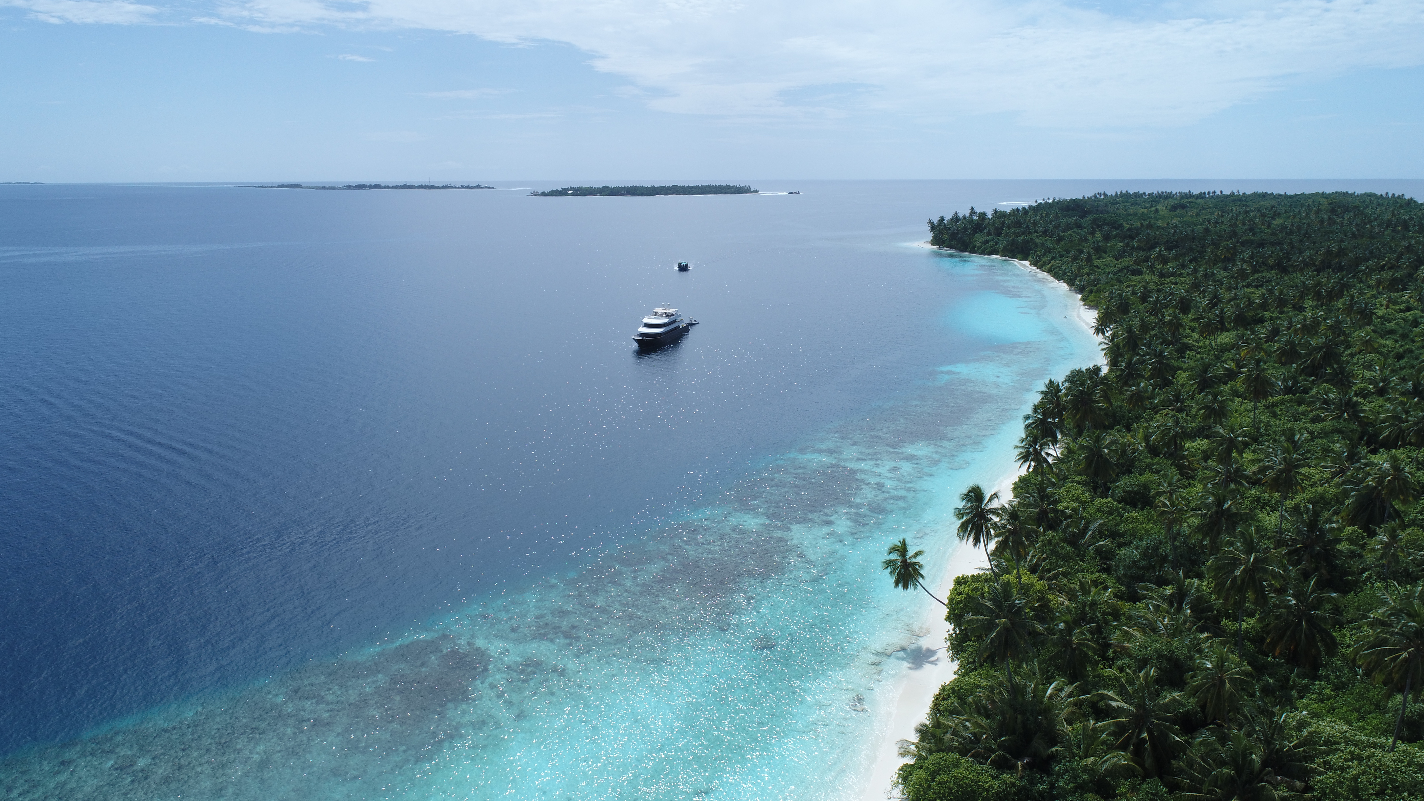 Azalea arriving at a Maldives resort to welcome guests aboard for a private yacht day trip or overnight stay.